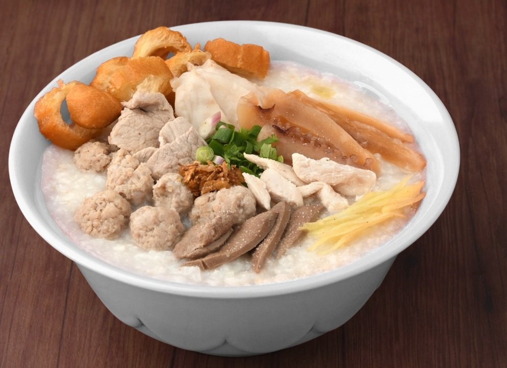 A bowl of Ming Kee porridge with spring onion and youtiao